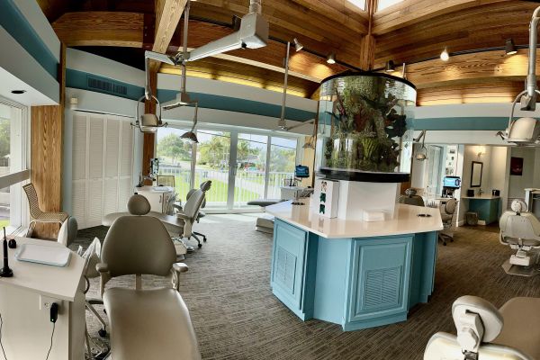 Interior view of the treatment area at Freeman Orthodontics, featuring a large aquarium as the central focal point and modern dental equipment